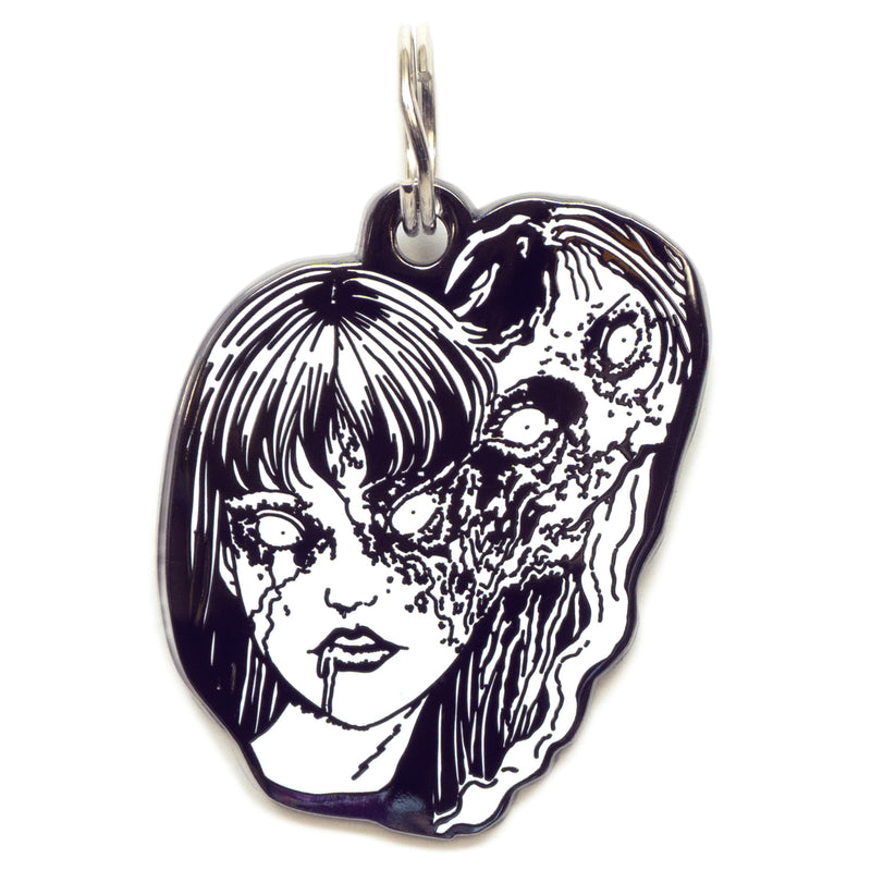  A pet tag featuring Tomie, a captivating yet terrifying character from Junji Ito's manga, known for her alluring beauty and supernatural ability to regenerate.